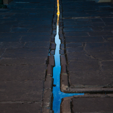 Sunrise lights up sidewalk drain, Lafayette Square, New Orleans.