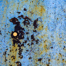 Bullet hole in rusted metal, Death Valley.